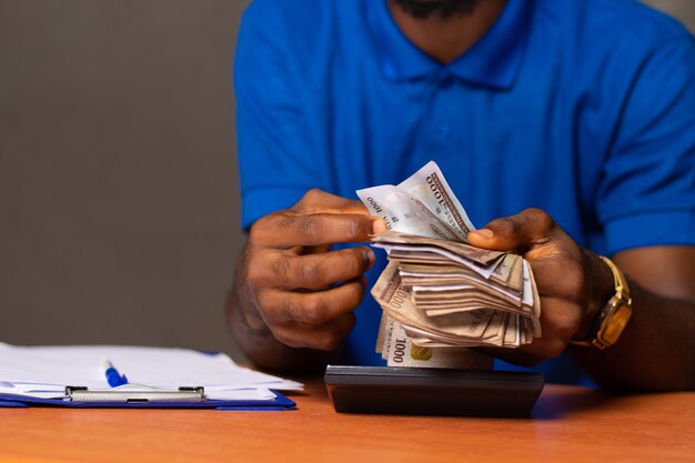 nigerian-man-counting-some-money_216356-627